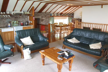 The well equipped, comfortable lounge, kitchen and dining area. Notice the piano for guests' use.